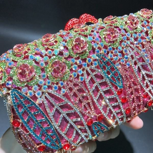 Detailed close-up of a handmade crystal evening bag with floral rhinestone patterns
