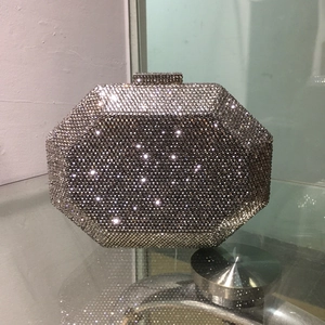 Detailed macro view of the silver crystal encrusted octagonal clutch with diamond clasp