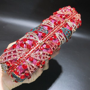 Detailed view of luxury evening clutch featuring colorful crystals and metal floral frame
