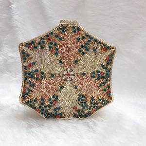 Detailed close-up of a luxury hexagonal evening bag featuring colorful snowflake crystals
