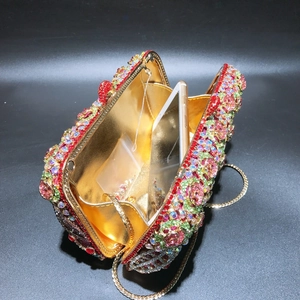 Detail of luxury rhinestone evening bag with gold lining and interior capacity view