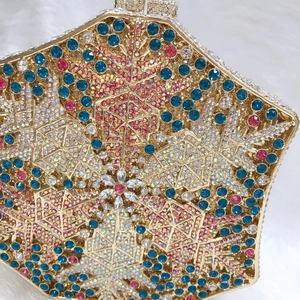 Close-up of luxury snowflake evening bag with colorful crystals and gold metal frame