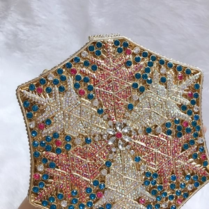 Close-up of snowflake pattern crystal evening bag with intricate colorful rhinestones