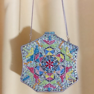 Detailed close-up of a hexagonal evening clutch with colorful geometric rhinestone patterns