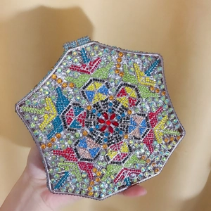 Macro view of colorful crystals and geometric flower pattern on hexagon evening bag