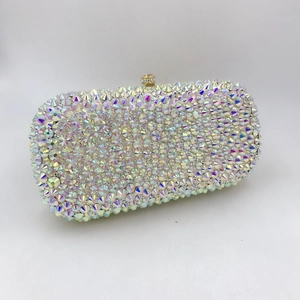 Detailed view of hand-set AB crystals and gold spherical clasp on the evening clutch bag