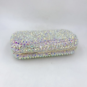 Macro shot of an oval evening clutch with hand-set AB iridescent rhinestones and gold frame