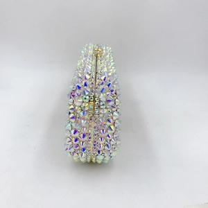 Detail view of the sleek gold metal frame and sparkling AB crystal rhinestones on the clutch