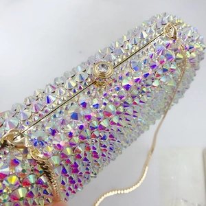 Macro shot of colorful AB rhinestones and gold metal frame on an elegant evening bag