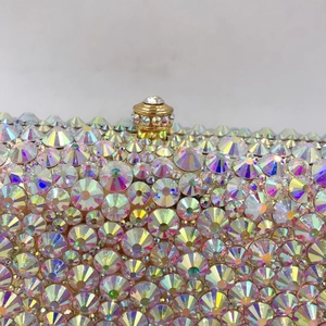 Close-up of handmade evening bag with AB crystals and golden metal clasp detail