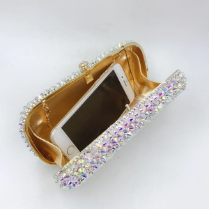 Internal view of luxury rhinestone evening bag showing capacity with a smartphone
