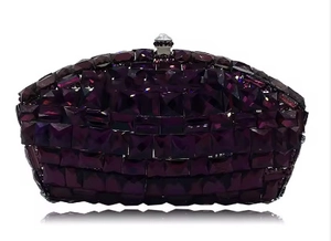 Macro shot of dark purple crystal rhinestones on the bridal evening clutch bag