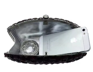 Luxurious crystal evening bag interior view with silver chain and smartphone for scale