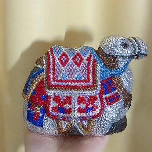 Detailed close-up of handmade camel clutch evening bag with colorful crystals