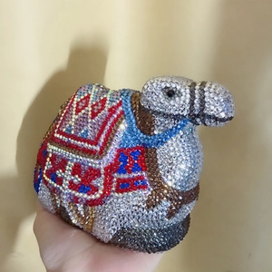 Macro shot of handcrafted crystal camel evening bag with detailed colorful rhinestones