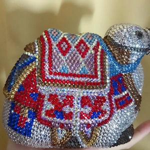 Detailed view of handmade camel-shaped clutch bag with multi-color geometric crystal patterns