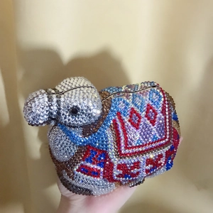 Detail showing multi-colored crystal rhinestones on a camel-shaped luxury evening clutch bag