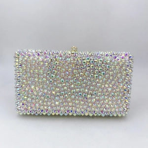 Macro shot of iridescent crystal-encrusted evening clutch with a decorative metal clasp