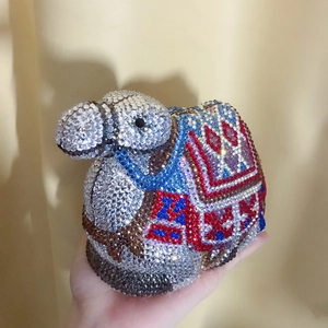 Macro view of crystal encrusted camel evening bag with intricate colorful rhinestones