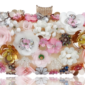 Close-up of 3D sequin flowers and crystal beadwork on champagne satin evening bag