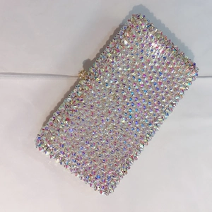 Macro shot of rectangular evening clutch featuring iridescent rhinestones and gold clasp