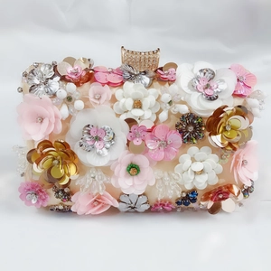 Detail of floral beaded evening clutch with sequins, crystals and gold diamond clasp