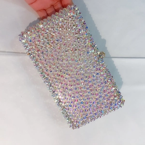 Macro detail of a rectangular evening clutch with hand-set iridescent AB rhinestones