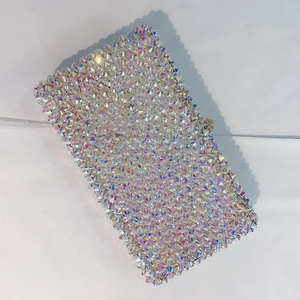 Macro view of crystal rhinestones on a rectangle evening clutch bag with AB finish