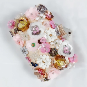 Top view of floral evening clutch bag showing spacious interior with a smartphone
