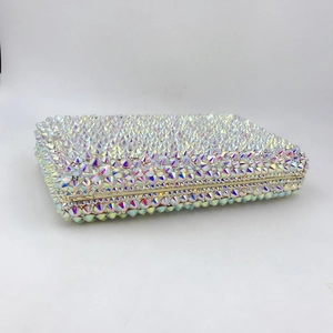 Macro detail of hand-set iridescent crystals on a luxury square clutch evening bag