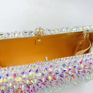 Macro detail of rainbow AB crystal evening bag with gold frame and chain attachment