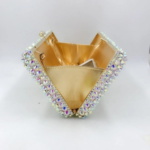 Macro shot of open evening bag with iridescent crystals and detachable gold chain