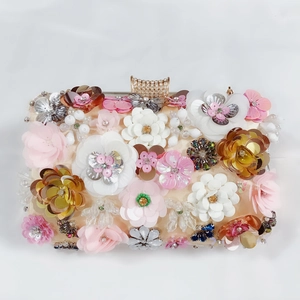 Detailed macro of 3D floral sequins and luxury rhinestone clasp on satin evening bag
