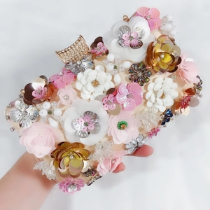 Detailed close-up of 3D floral evening bag with sequins, beads and crystal clasp
