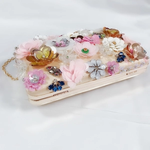Detail of satin evening clutch with 3D floral sequins and beaded diamond embroidery