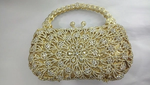 Détails du motif floral ajouré et des strass en cristal sur cette pochette de soirée