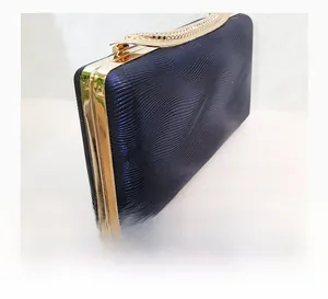 Detail of dark blue evening clutch with wave texture fabric and rhinestone-encrusted top