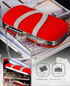 Close-up of red velvet evening bag showing inner capacity for phone and sunglasses