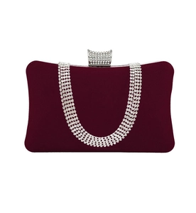 Detail of burgundy velvet evening bag with U-shaped rhinestone pattern and crystal clasp