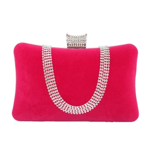 Close-up of rose red velvet evening bag featuring cascading rhinestones and a jeweled clasp