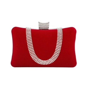 Detail of red velvet evening bag with U-shaped rhinestone chains and crystal clasp
