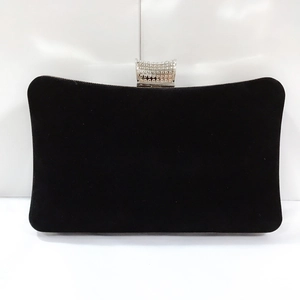 Detail of elegant black velvet evening bag with silver diamond-studded metal clasp
