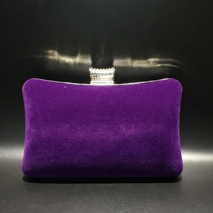 Detail of purple velvet evening clutch featuring a U-shaped crystal rhinestone clasp