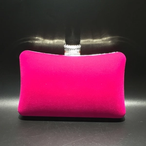 Detailed view of hot pink velvet evening clutch bag with sparkling rhinestone top clasp