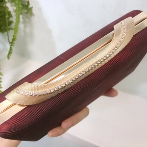 Elegant burgundy PU leather evening clutch bag with gold trim and rhinestones