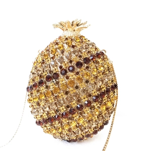 Macro detail of luxury pineapple crystal evening clutch with amber gold diamonds
