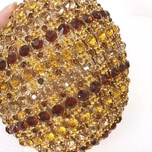 Macro shot of colorful sparkling crystals and rhinestones on this round luxury clutch bag