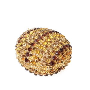 Detailed view of luxury pineapple clutch with hand-set amber and gold crystals