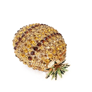 Macro detail of pineapple shaped evening clutch featuring intricate crystal embellishments