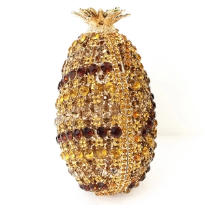 Detailed view of luxury gold pineapple clutch bag with crystal rhinestones and leaf clasp